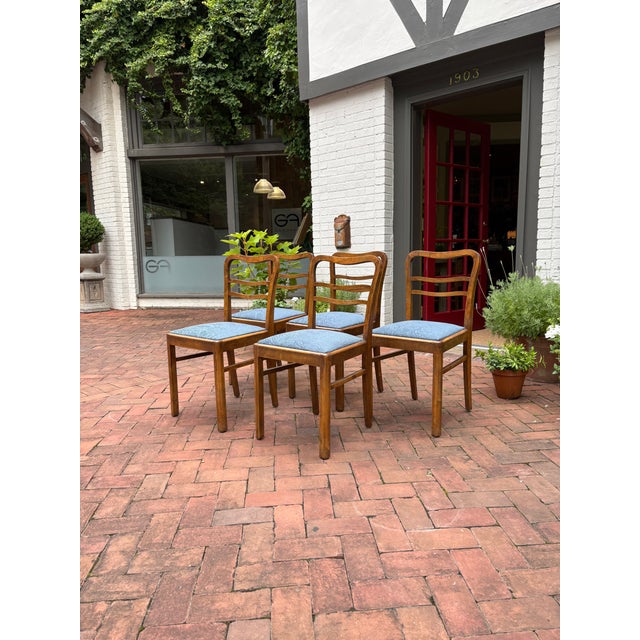 A striking set of five mid-century Polish dining chairs crafted from solid beech with gracefully sculpted ladder-back...