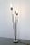 This floor lamp was designed and manufactured by Stilnovo in the 1950s and features three opaline glass tubes with stems...