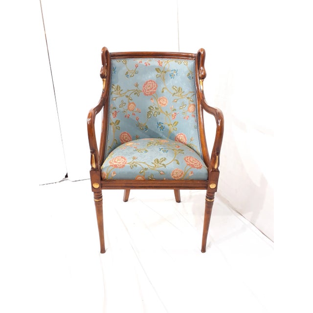 Beech armchair with hand-carved swan heads decorations in gold leaf and blue floral upholstery with Jacar processing....