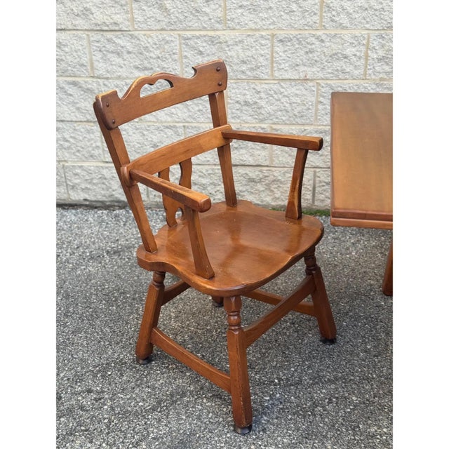 Solid wood construction with warm medium-tone finish. Armchair with flat arms; side chairs without arms. Side chairs:...