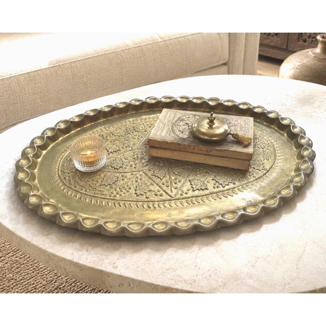 Large 24-inch vintage solid-brass wall tray with raised floral ornament, 1940s scalloped rim, and hanging hook for an...