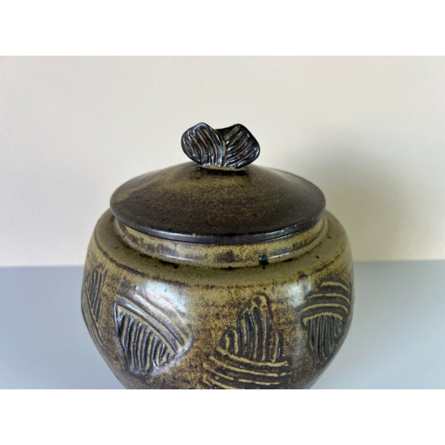 Available for sale this fantastic Mid-century speckled glaze studio pottery jar with lid. The jar has a beautiful artistic...