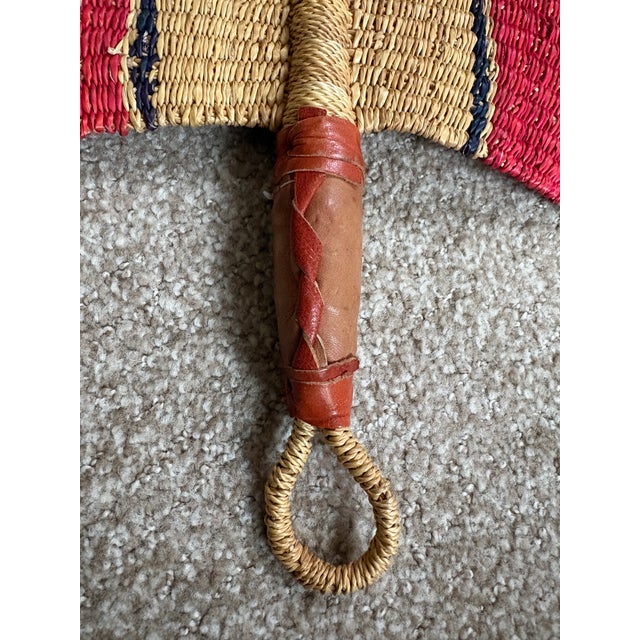A medium/large, hand woven fan with leather handle great for his proper use or for dressing up your home. Acquired at an...