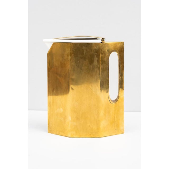 Brass carafe, Made in Italy, 1950s. Extraordinary brass carafe and lid with white ceramic interior. It is recommended to...