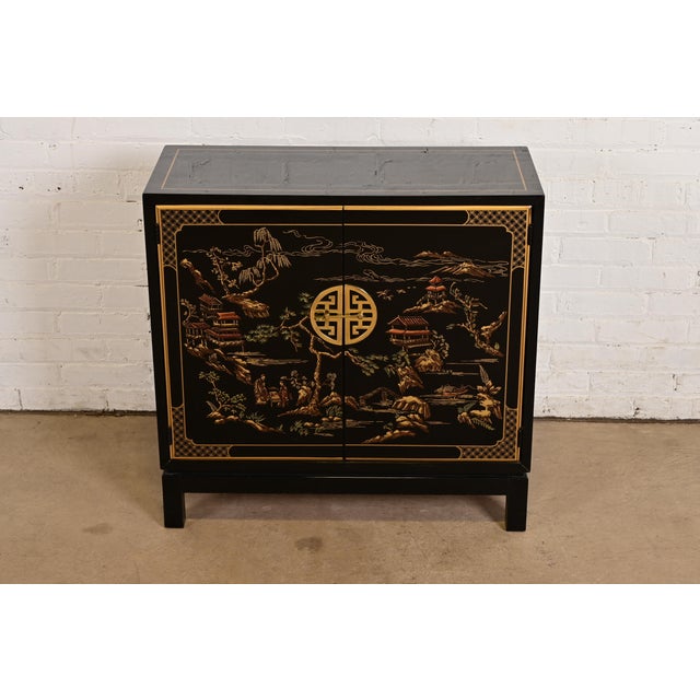 A gorgeous Hollywood Regency Chinoiserie bar cabinet By Drexel Heritage USA, Circa 1980s Black lacquered mahogany, with...