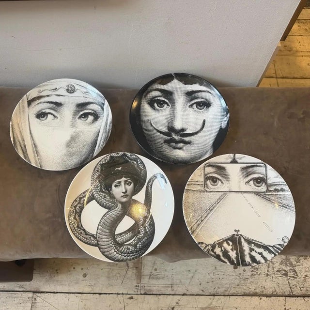 An exquisite and rare set of four vintage Tema e Variazioni black and white porcelain wall plates designed by Piero...