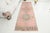 This is a vintage Turkish Oushak rug from the Mid 20th Century. The piece was hand-knotted.