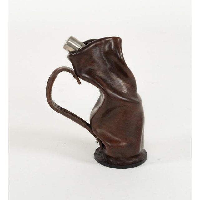 Midcentury amazing liqueur bottle in curved brown leather, glass and metal with handle. Made in Italy in the 1960s.
