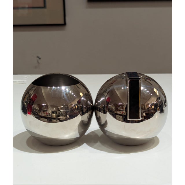 Award-winning NIO collection by Oliver Hemming. Polished 18/10 stainless steel sugar bowl and creamer featuring spherical...
