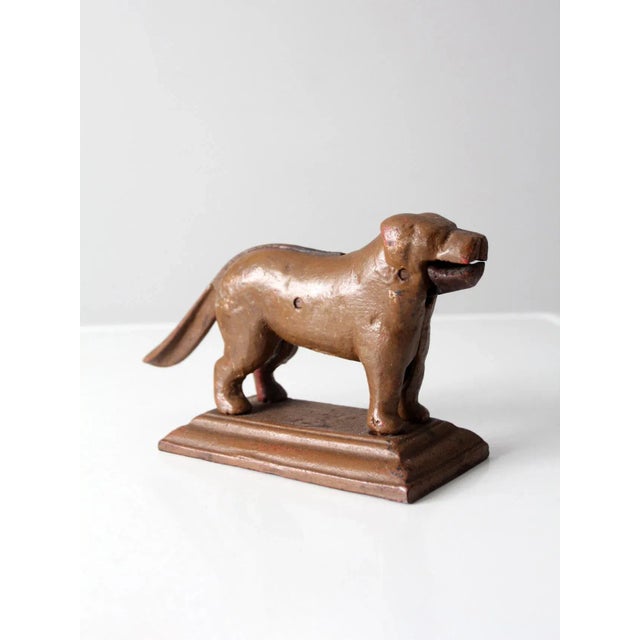 This is an antique painted cast iron nutcracker circa early 20th century. Shaped as a dog, one can place a nut in the...
