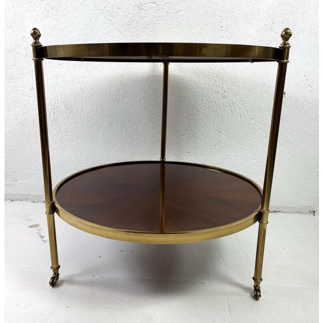 This is an elegant mid-century vintage Hollywood Regency style walnut and brass side table by Baker furniture. This table...