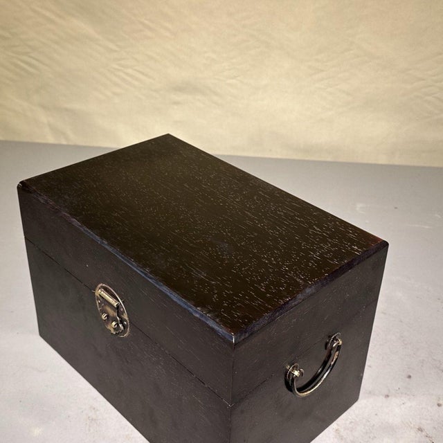 This handsome rectangular storage chest is a modern reproduction of a traditional Chinese scholar’s treasure box, crafted...