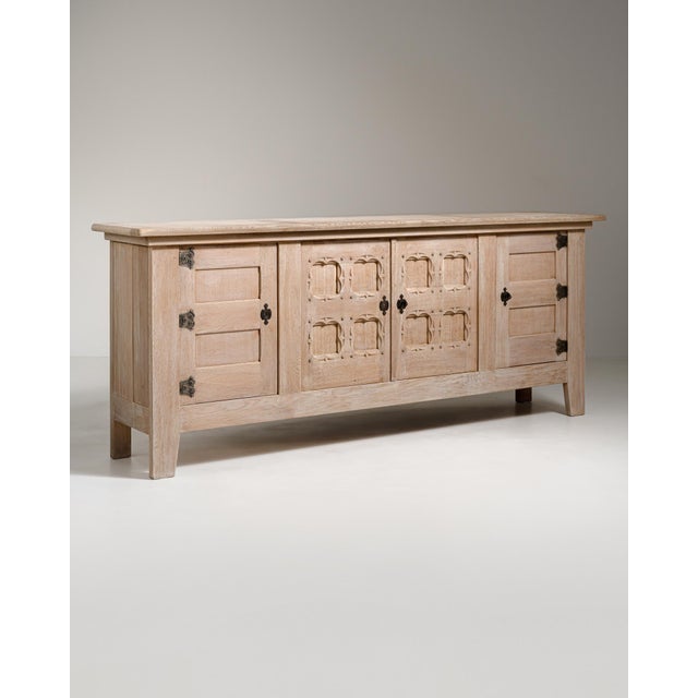 Executed in France circa 1970, this commanding oak buffet exemplifies the raw, sculptural energy of the Brutalist movement...