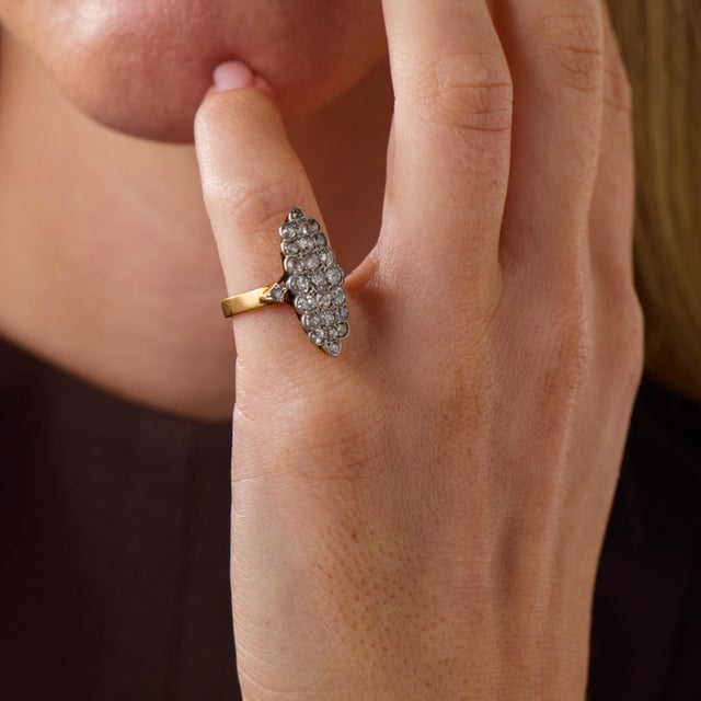 This elegant French Belle Époque navette ring is a beautifully elongated jewel from the 1910’s, set with 23 old European...