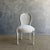 20”w x 21”d x 38”h SH: 20” SD: 17” Antique French Louis XVI Style Cane chair painted in a french oyster white finish with...