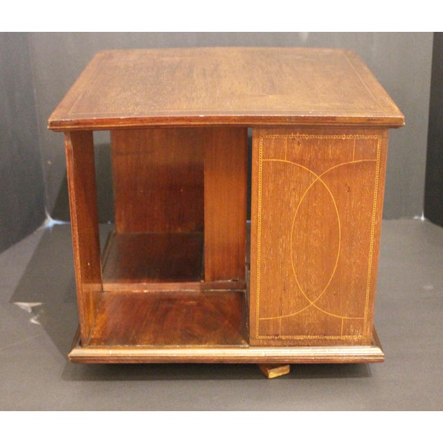 Early 20th English Edwardian period tabletop revolving bookcase. Mahogany with neoclassical line & barber pole inlays. A...