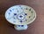Traditional cobalt blue pattern. The bowl rests on three sculptured dolphins supporting the hand painted bowl
