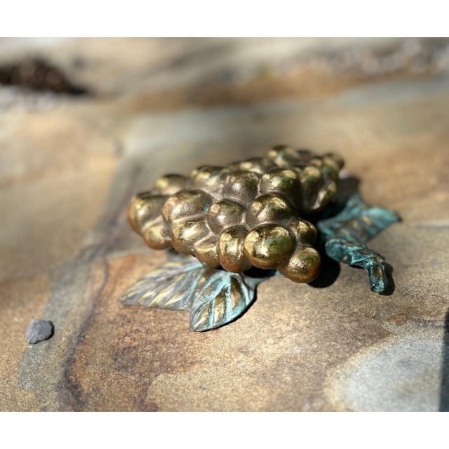 A charming vintage solid brass door knocker in the form of a grape cluster, complete with sculptural leaves and stem...