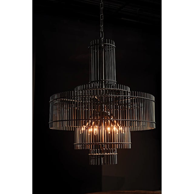This elegant metal chandelier has been expertly artisan crafted and finished in matte black and frosted glass. This lamp...