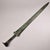 This is a cast bronze sword featuring a double-edged blade with a raised central ridge and a pointed tip. The blade is...