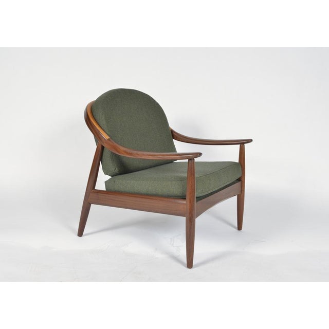 This stunning 1960s curved spindle back lounge chair in teak, was made by the highly revered english company greaves &...