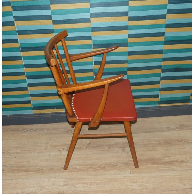 A particularly beautiful, rustic chair from the 1950s/60s Finely crafted beechwood frame with a slatted back and armrests...