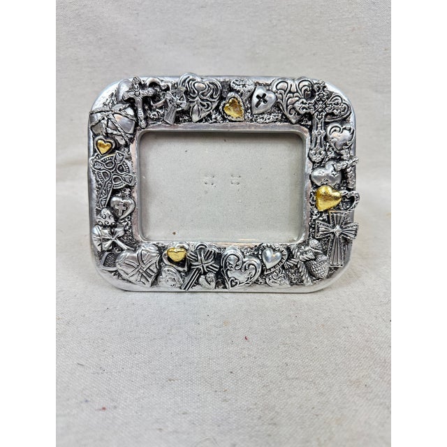 Lovely vintage picture frame. Features crosses and hearts in silver and gold. Opening is 3” x 4.5”. Perfect to give as a...