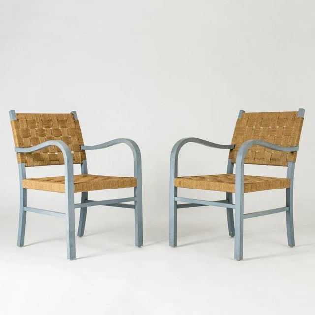Pair of beautiful armchairs by Axel Larsson, with curved armrests creating lovely, open silhouettes. Painted sky blue,...