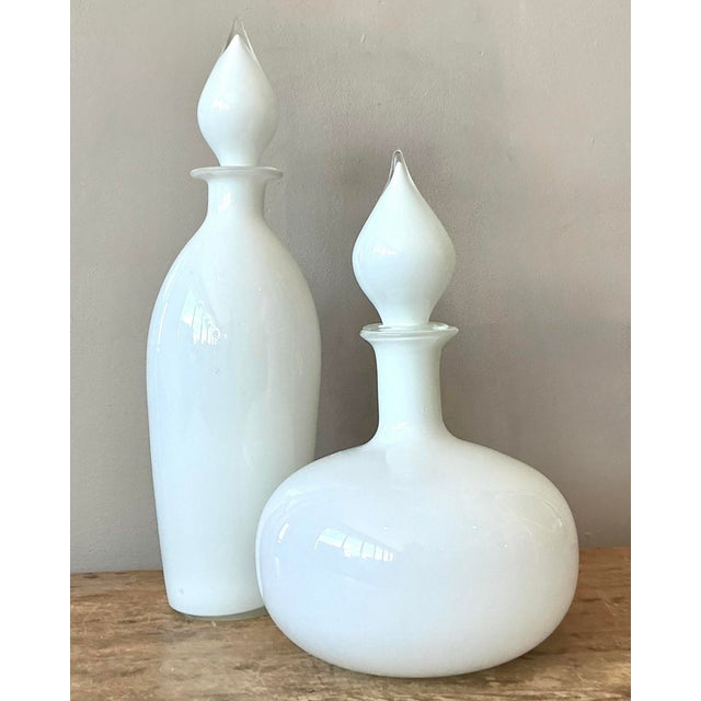 Elevate your bar cart or vanity with this striking pair of vintage Mid-Century Modern glass decanters. Reminiscent of the...