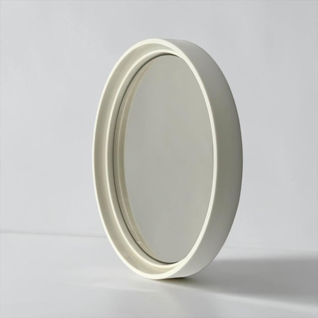 This round wall mirror was produced by Gilac in France during the 1970s and represents a distinctive example of Space Age...