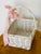 Cute lovely wicker basket painted white and decorated with a silk pink bow.