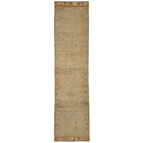 This exquisite runner rug is a rare example of tribal craftsmanship, hand-knotted by the women of the Herki tribe during...