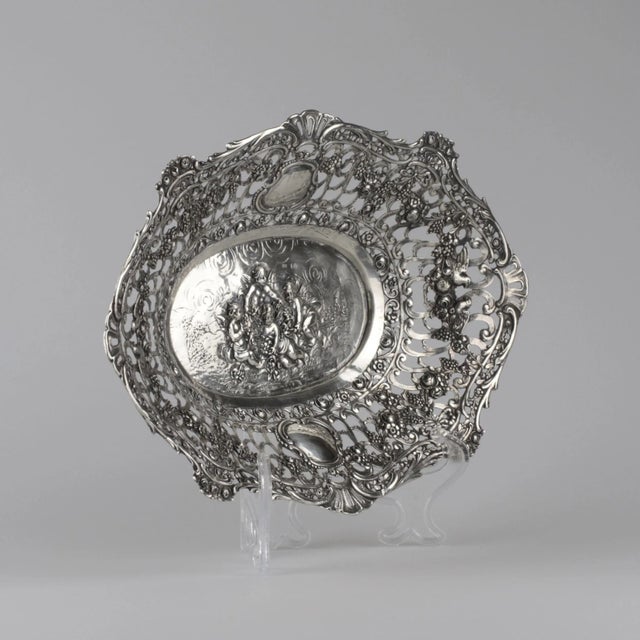 Decorative silver dish in the neo-rococo style , with cut-out decor of the fields, vignettes under the initials; with...