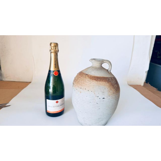 This French pottery jar from the 1950s-1960s, crafted in an artisan workshop on the Côte d'Azur, embodies the rustic charm...