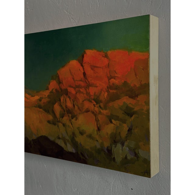 Incandesce presents a striking landscape where bold, fiery hues of orange and red contrast against a deep, teal sky. The...