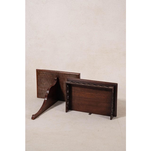 Pair of English mahogany wall brackets with carved shelves, shaped supports, and rich wood grain.