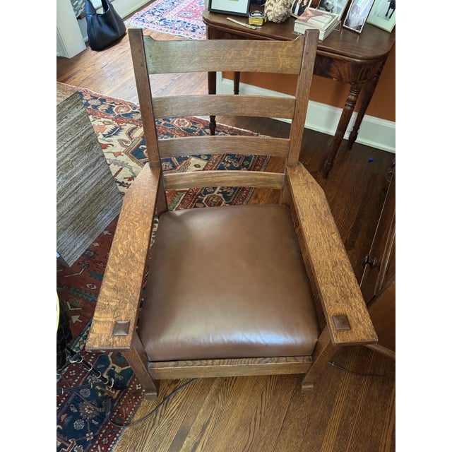 A beautifully restored antique Mission-style oak rocking chair featuring a newly upholstered leather seat by Willow Branch...