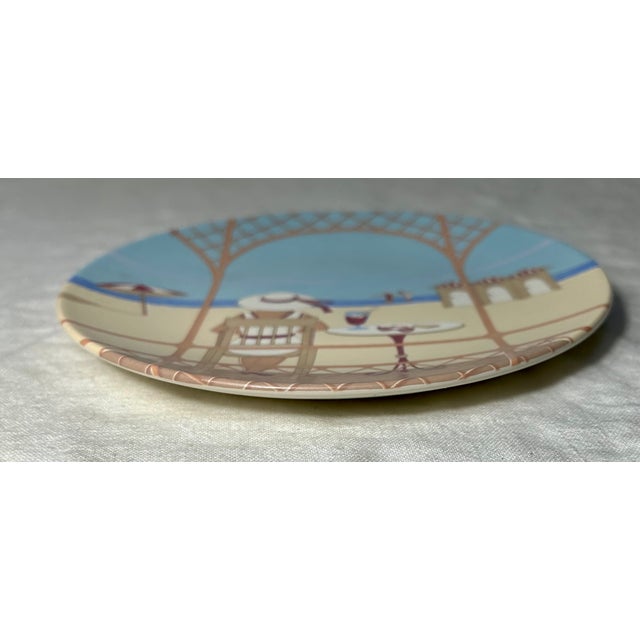 “This transfer plate depicting an elegant lady looking across a beach while sitting on a terrace, is from one of several...