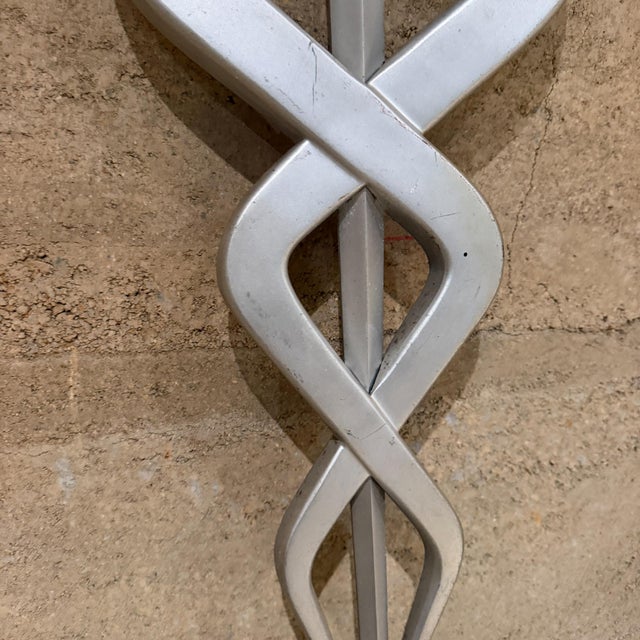 For your consideration, an aluminum caduceus symbol—featuring a staff intertwined with two snakes and topped with...