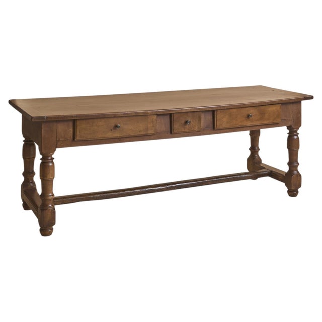A 19th century French dining table crafted in solid walnut, distinguished by its generous proportions and enduring...