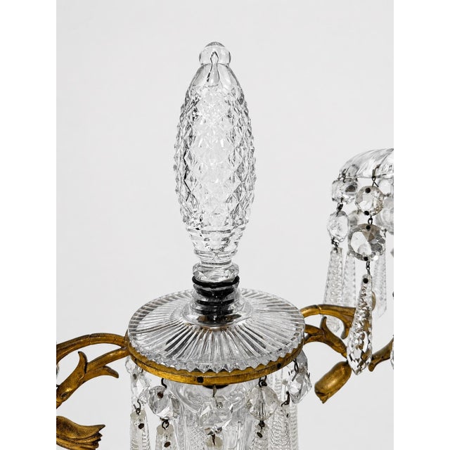 A finely decorative pair of late 19th century French or Continental cut-crystal and gilt-metal candelabra, conceived in...