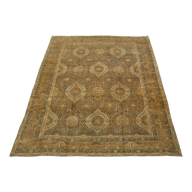 Discover the charm of this exquisite hand-knotted rug, a true antique from the 1880s. Its stunning blue and tan field,...