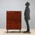 1960s vintage sideboard made of stained mahogany veneer, featuring a functional and linear design. Equipped with a drop-...