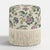 Elevate your living space with the Tambor Ottoman with Fringe in an exclusive Tree of Life printa delightful blend of...