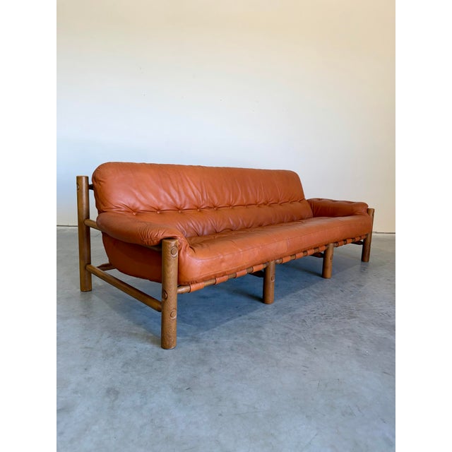1970’s Brazilian Modern style 3 seat sofa in Cognac leather and Oak frame. Styling is a nod to Sergio Rodriguez, Percival...