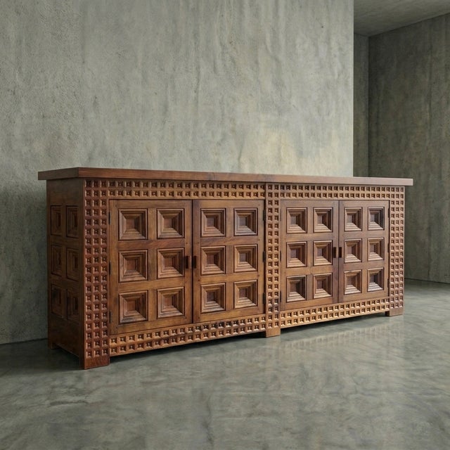 Rhythmic geometry meets raw materiality in this commanding 1960s Spanish brutalist case piece. Deeply faceted pyramid...