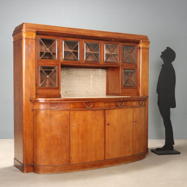 Early 20th-century mahogany sideboard featuring a raised section with five beveled glass doors, adorned with elegant brass...
