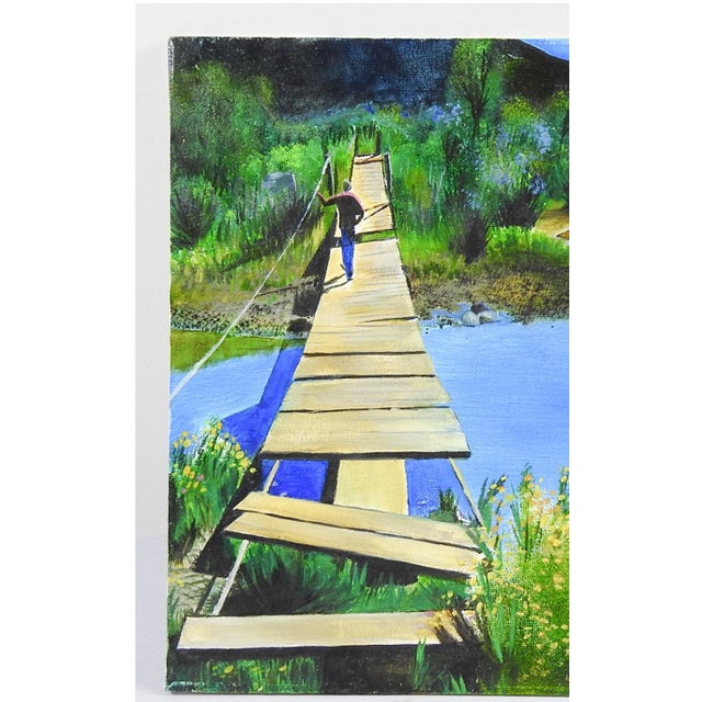 Late 20th century acrylic on canvas board painting of crossing at old foot bridge over a river with mountain landscape in...