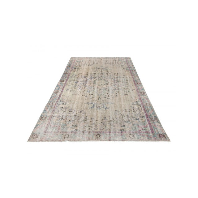 Decorative washed out handknotted vintage rug from Oushak region of Turkey. Approximately 50-60 years old. In very good...