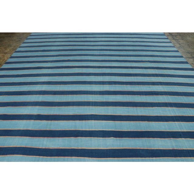 This 11x14 vintage rug is from a new collection of Dhurrie flat weaves in rare sizes and exceptional craftsmanship—an...